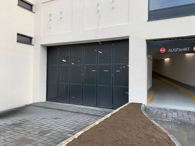 Porte coulissante pliante à commande manuelle pour la zone de livraison de la résidence pour seniors Alloheim